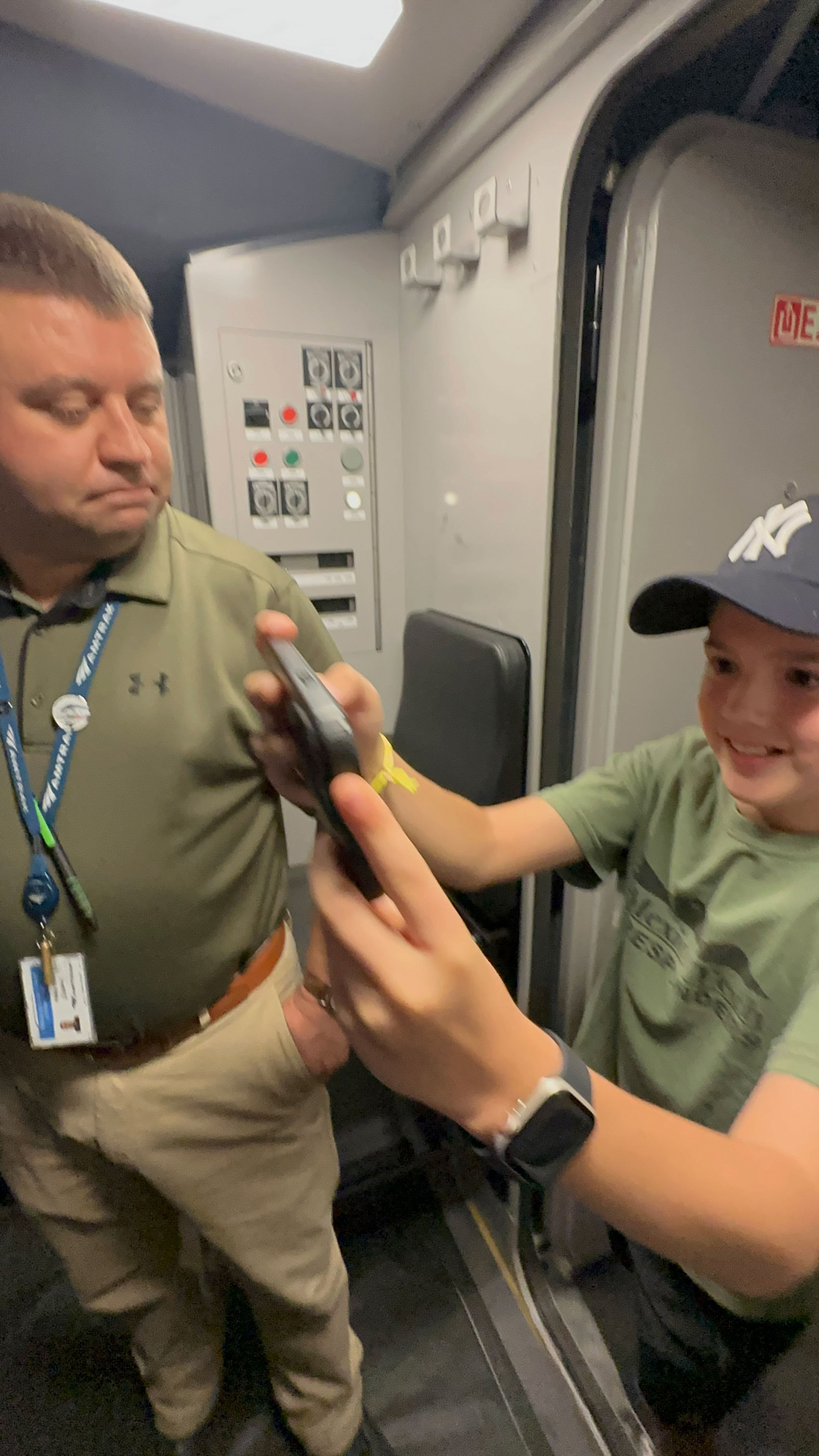 Amtrak engineer Phil Meade shows off the cab of the new Acela Express to Oliver Lees, a 12-year-old from Queens, after the train’s arrival at Moynihan Train Hall in Penn Station.