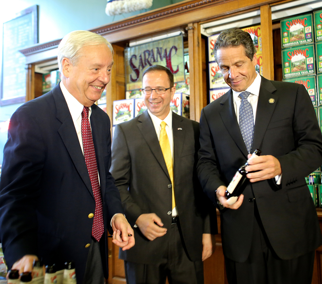 Andrew Cuomo looking at a beer