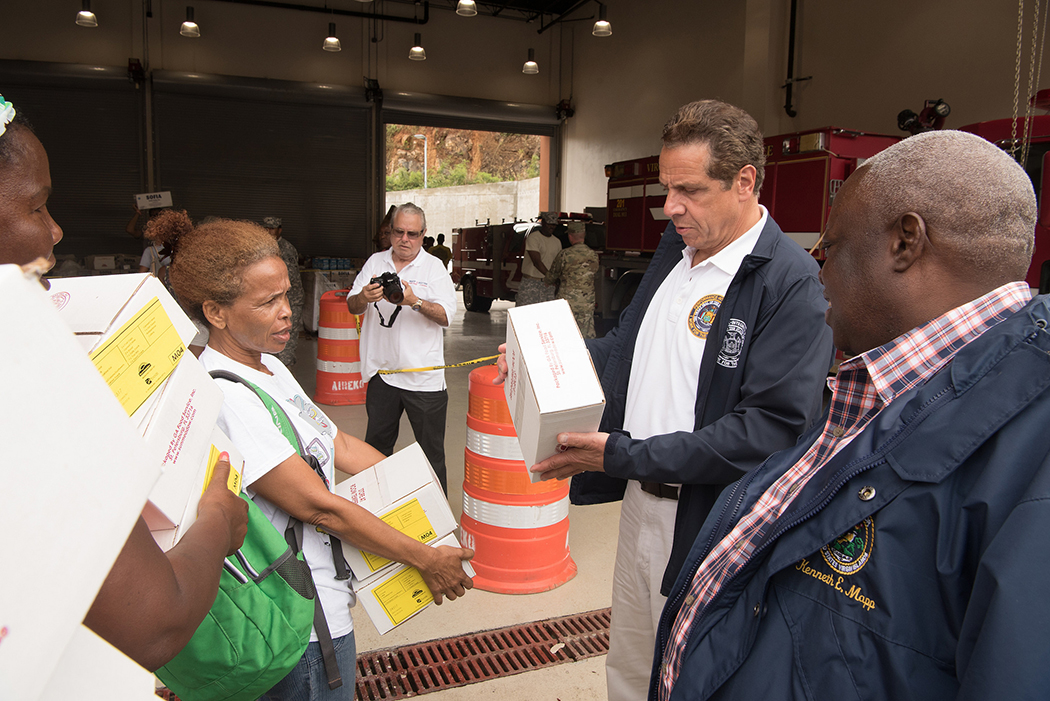 Andrew Cuomo looking at a box
