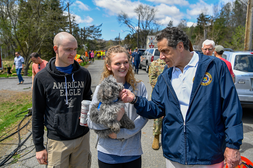 Andrew Cuomo looking at a dog