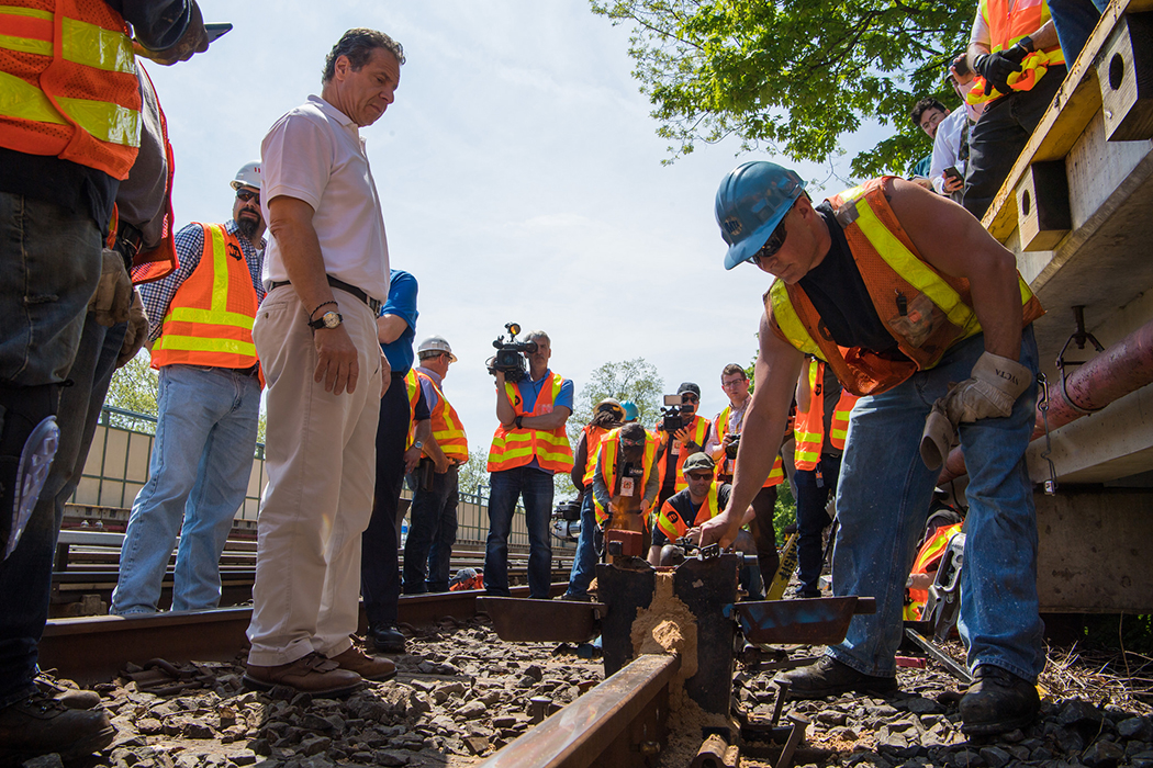 Andrew Cuomo looking at train tracks