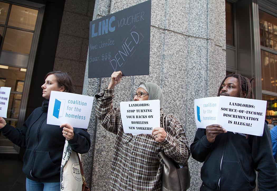 Coalition for the Homeless staff and advocates protest source of income discrimination outside a realty office in November, 2016.
