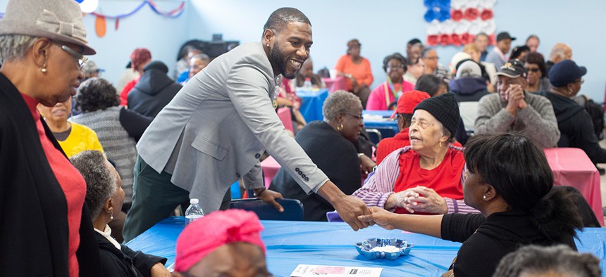 New York City Councilman Jumaane Williams shakes hands at the Canarsie Senior Center on Veterans Day.